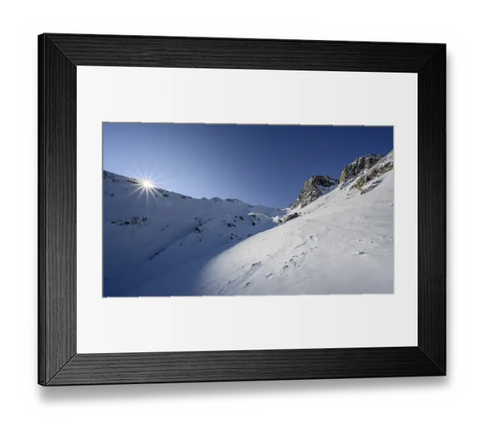 Framed Print : Sun shines over mountain ridges
