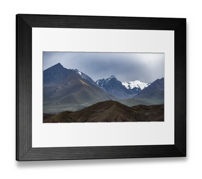 Framed Print : Twilight over snow-covered mountain peaks and steep slopes Framed Print : Twilight over snow-covered mountain peaks and steep slopes