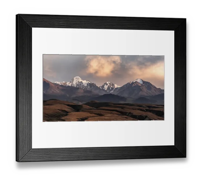 Framed Print : Snow-covered and glaciated mountain peaks at sunset Framed Print : Snow-covered and glaciated mountain peaks at sunset