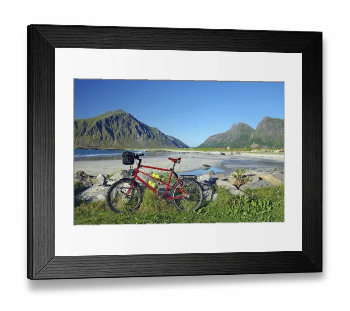 Framed Print : A bicycle on the beach with a view of the surrounding mountains and the sea