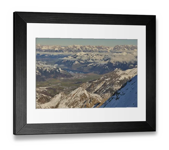 Framed Print : View from Mount Kitzsteinhorn on snow covered mountains down to Zell am See Framed Print : View from Mount Kitzsteinhorn on snow covered mountains down to Zell am See