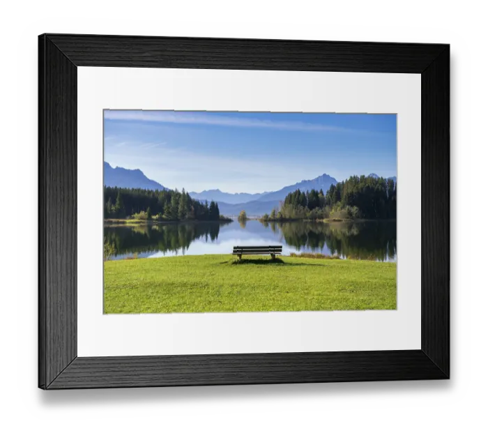 Framed Print : A calm lake surrounded by mountains