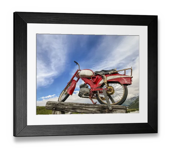 Framed Print : An old rusty red motorcycle stands on a wooden pole