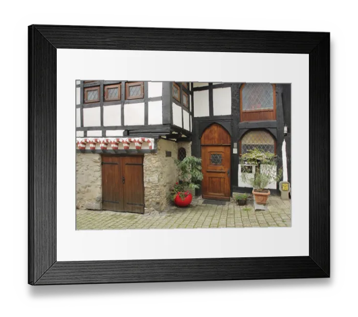 Framed Print : Half-timbered house built in 1292 with wooden door and decoration