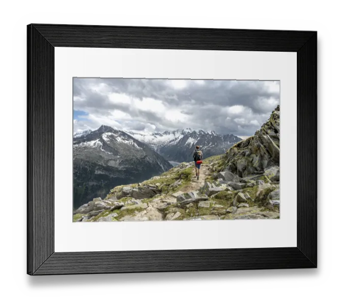 Framed Print : Mountaineer on hiking trail with snow