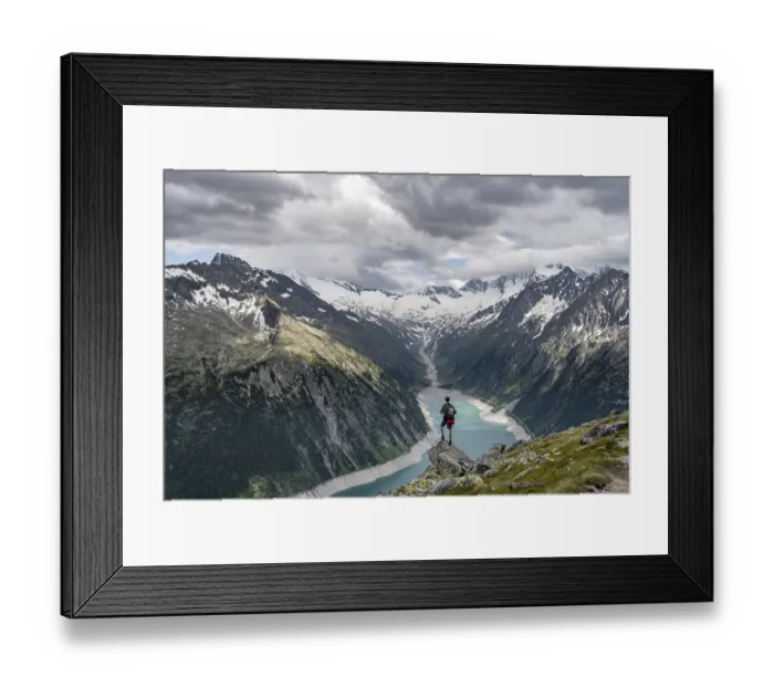 Framed Print : Mountaineer on a rock in front of a mountain panorama Framed Print : Mountaineer on a rock in front of a mountain panorama