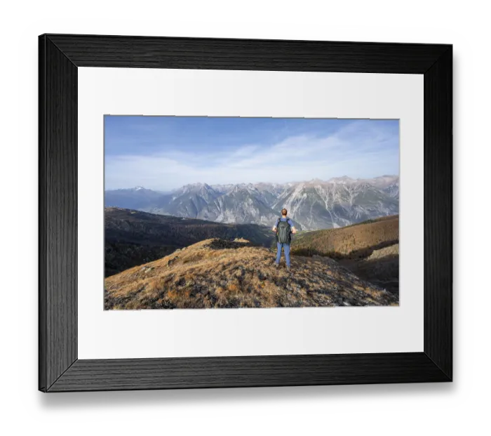 Framed Print : Mountaineer in front of a mountain panorama on a mountain ridge