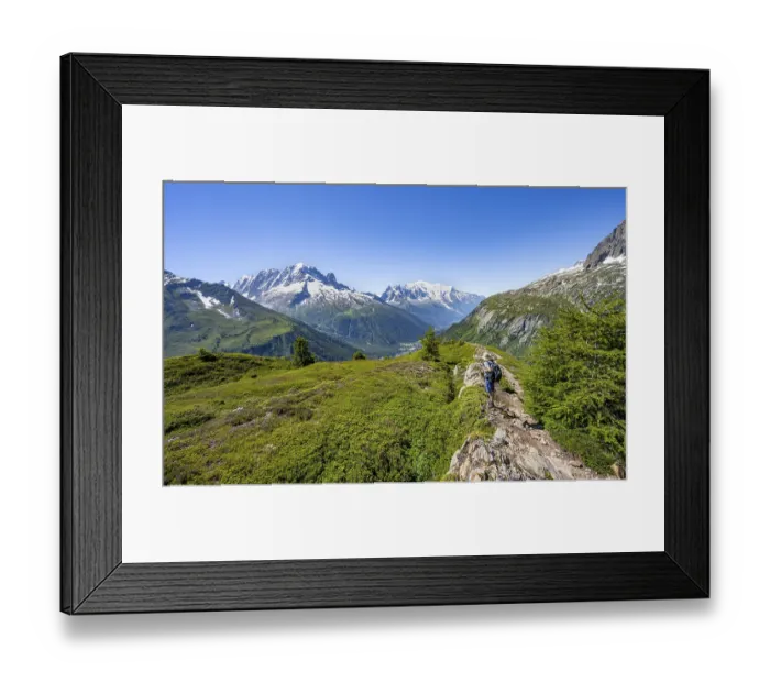 Framed Print : Mountaineer in front of a mountain panorama with glaciated mountain peaks
