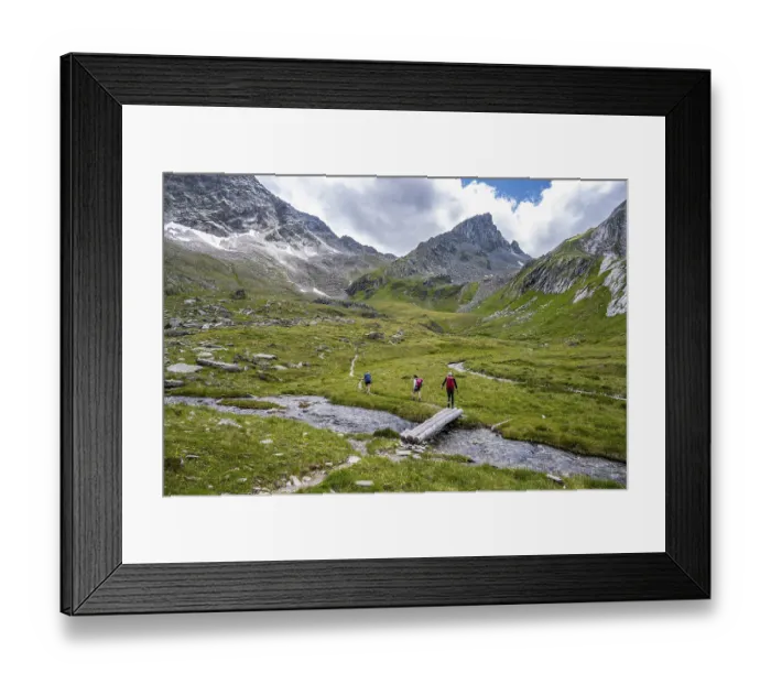 Framed Print : Hiker on hiking trail, stream with bridge