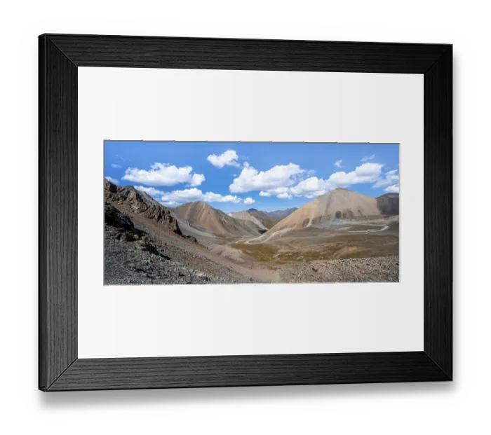 Framed Print : Mountain road through a colourful mountain landscape
