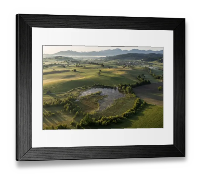 Framed Print : Aerial view of a lake in front of mountains in summer