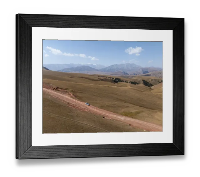 Framed Print : Moldo-Ashuu Pass, car on road between yellow hills