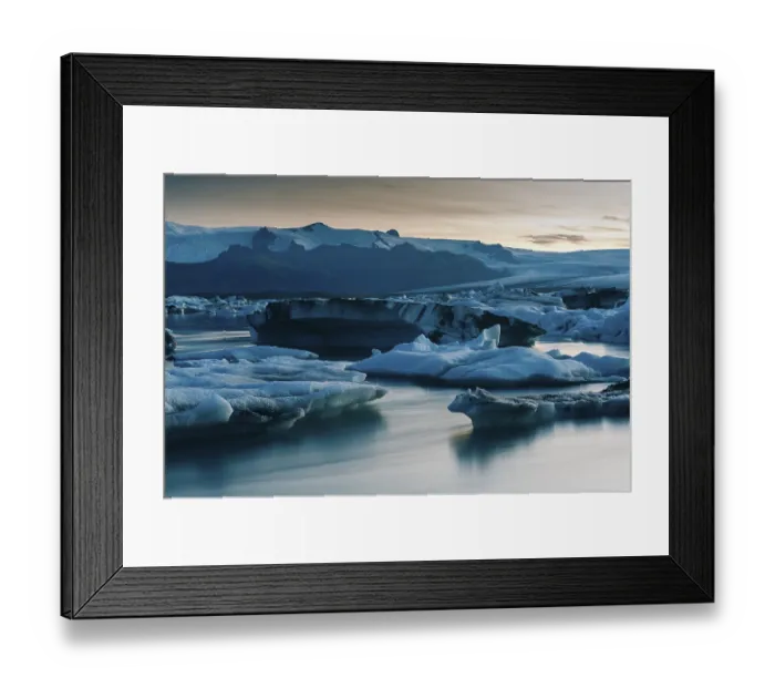 Framed Print : Icebergs and a calm glacial lake at dusk