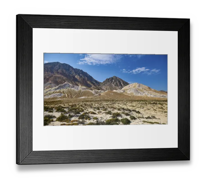Framed Print : Vast desert-like landscape with volcanic rock and mountain range under a clear sky