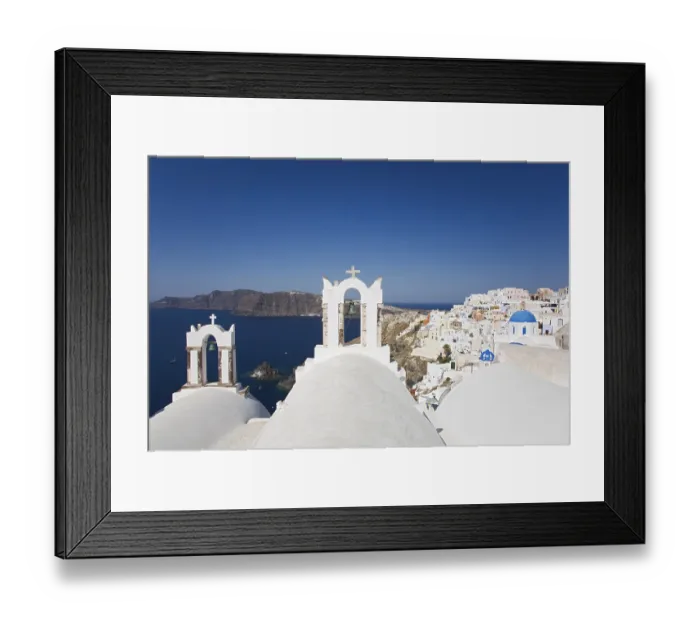 Framed Print : Two bell towers overviewing Oia and the Caldera