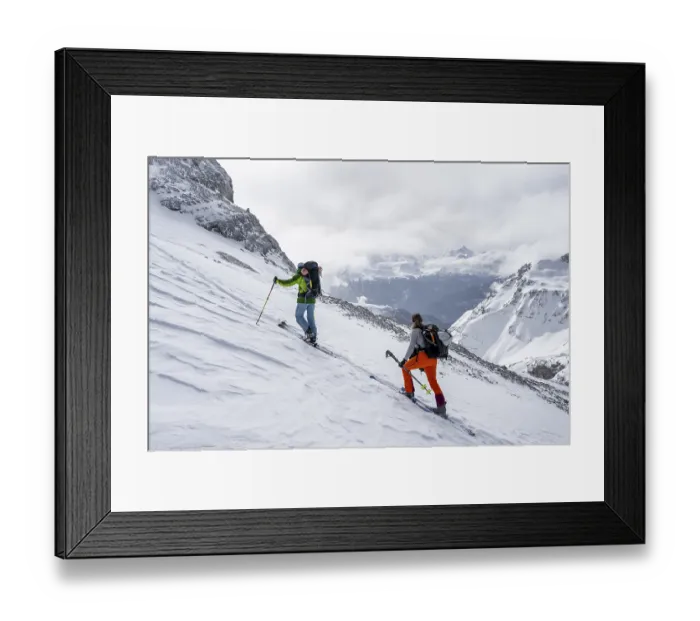 Framed Print : Ski tourers in a snowy mountain landscape