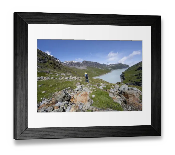 Framed Print : Mountaineer on hiking trail in front of Lac des Dix reservoir