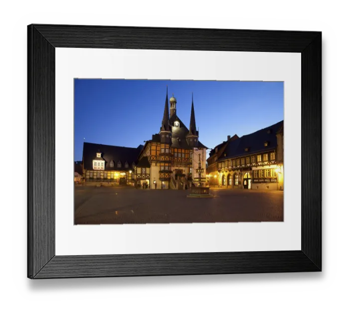 Framed Print : Illuminated town hall in the market square at dusk