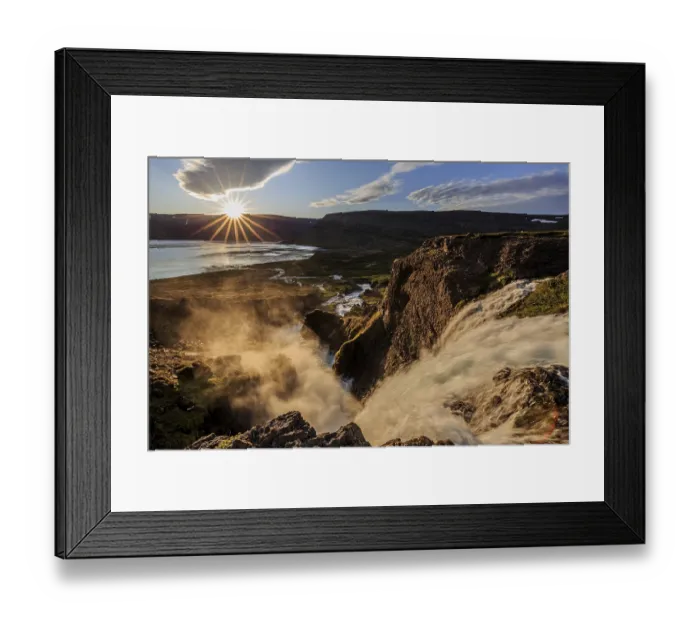 Framed Print : Waterfall backlit by midnight sun in front of mountains and coast