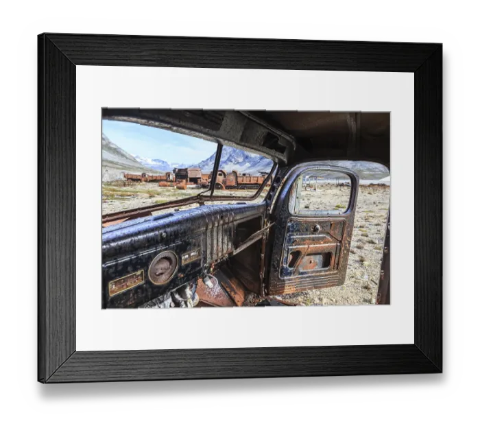 Framed Print : Interior view of a rusty car in front of steep mountains