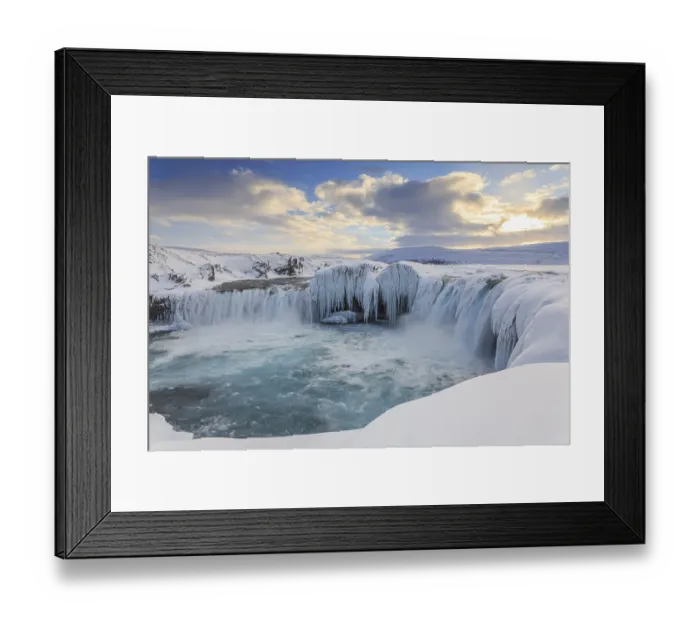 Framed Print : Icy waterfall and rapids in front of a mountain landscape