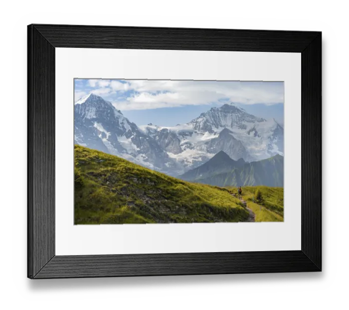 Framed Print : Hiker on hiking trail, snow-covered mountain peaks Framed Print : Hiker on hiking trail, snow-covered mountain peaks