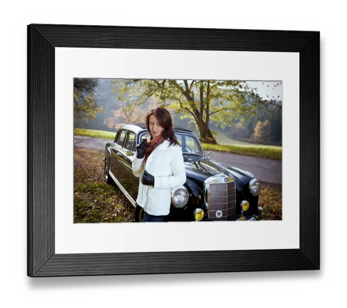 Framed Print : Young woman in front of post-war classic car