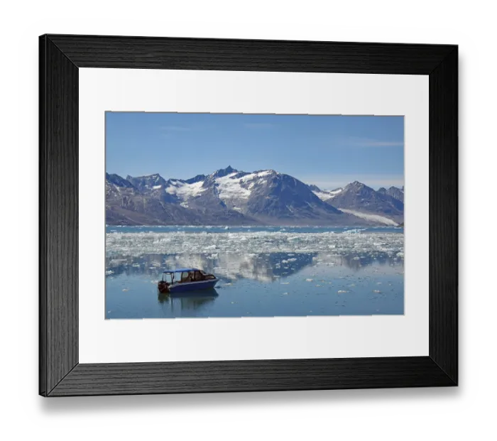 Framed Print : Icebergs reflected in a fjord, small blue boat