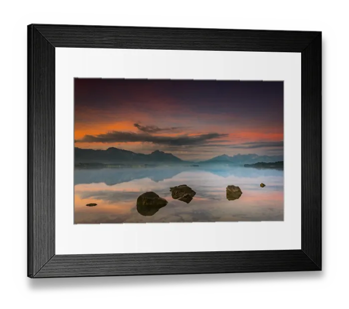 Framed Print : Forggensee with reflection of the cloudy sky and the Allgaeuer mountains in the background at sunrise Framed Print : Forggensee with reflection of the cloudy sky and the Allgaeuer mountains in the background at sunrise