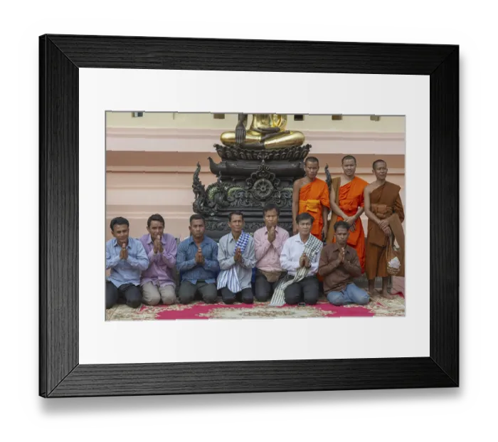 Framed Print : Monks and Laotians in front of a Buddha statue
