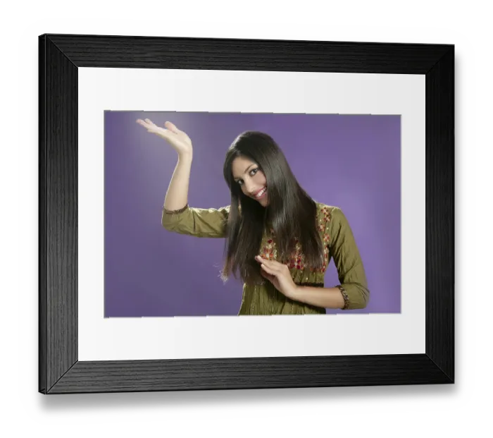 Framed Print : Beautiful indian young brunette woman posing hands on purple background