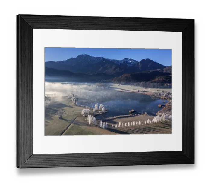 Framed Print : Aerial view of a lake in front of mountains in winter