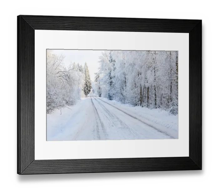 Framed Print : Winter road in a woodland with snow and frost