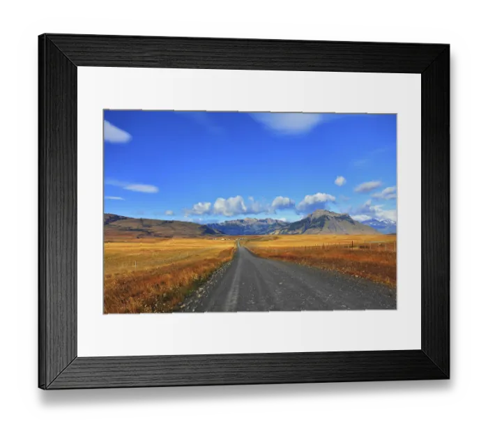 Framed Print : Steppes of Patagonia. Dirt road passes between the plains to the distant mountains