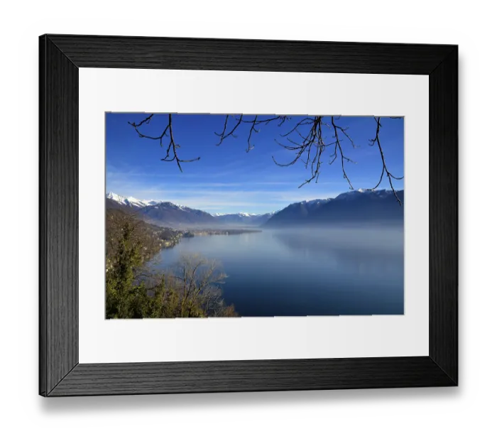 Framed Print : Panoramic View over Lake Maggiore with Snowcapped Mountain in a Misty Morning and in a Sunny Day in Ascona Framed Print : Panoramic View over Lake Maggiore with Snowcapped Mountain in a Misty Morning and in a Sunny Day in Ascona