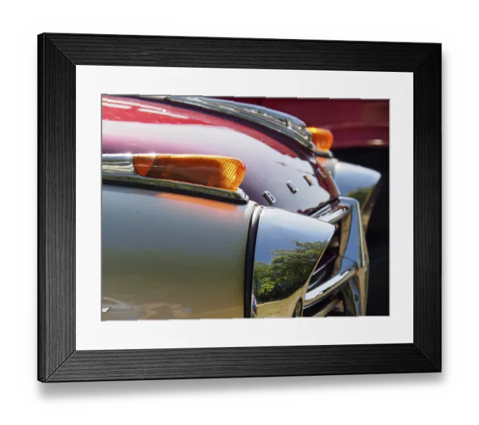 Framed Print : Detailed view of a vintage car with red paintwork and chrome accents