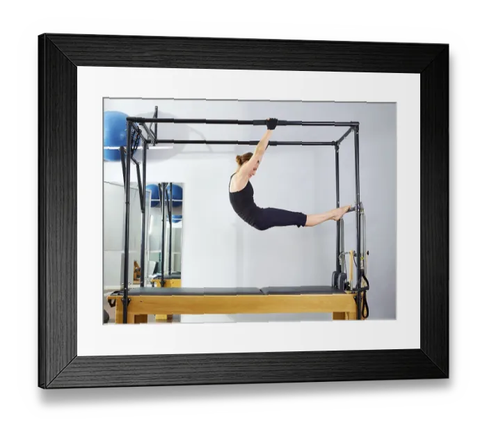 Framed Print : Pilates woman in cadillac acrobatic reformer exercise at gym Framed Print : Pilates woman in cadillac acrobatic reformer exercise at gym