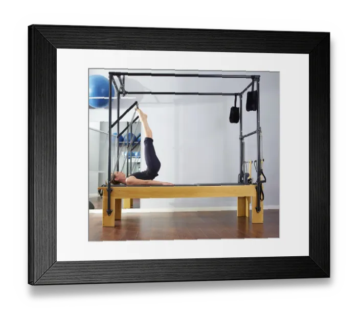 Framed Print : Pilates woman in reformer tower exercise at gym indoor