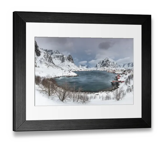 Framed Print : View of Reine with Reinefjord, snow-covered mountains at the back