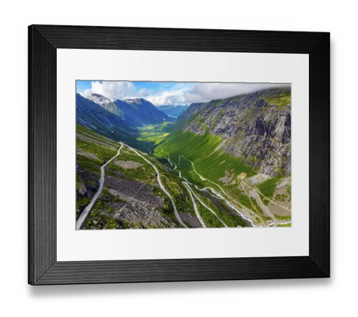Framed Print : The serpentine road meanders on the green slopes of the canyon