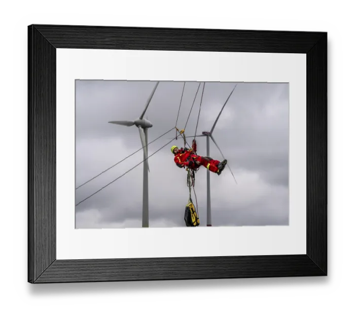 Framed Print : Height rescuers from the Oberhausen fire brigade practise abseiling from a wind turbine from a height of 150 metres