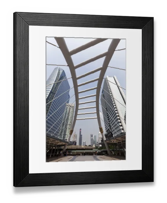 Framed Print : High-rise buildings in the business district Sathon and pedestrian bridge to BTS Skytrain station Chong Nonsi