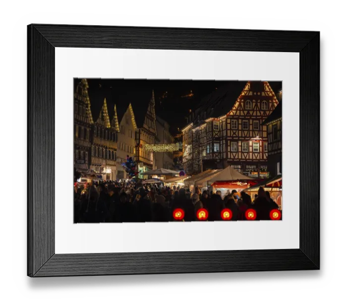 Framed Print : Densely packed crowd at an atmospherically illuminated Christmas market with half-timbered houses Framed Print : Densely packed crowd at an atmospherically illuminated Christmas market with half-timbered houses