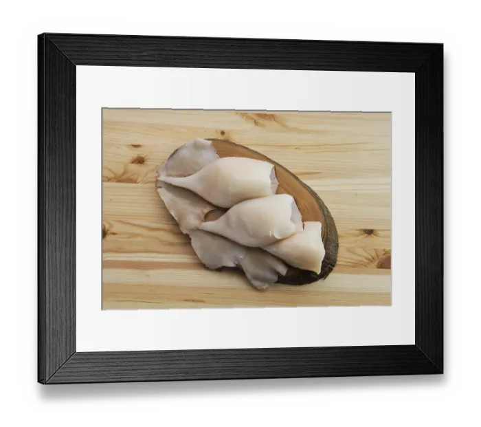 Framed Print : Top view of frozen pilled squid on wooden table