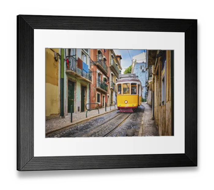 Framed Print : Famous vintage yellow tram 28 in the narrow streets of Alfama district in Lisbon