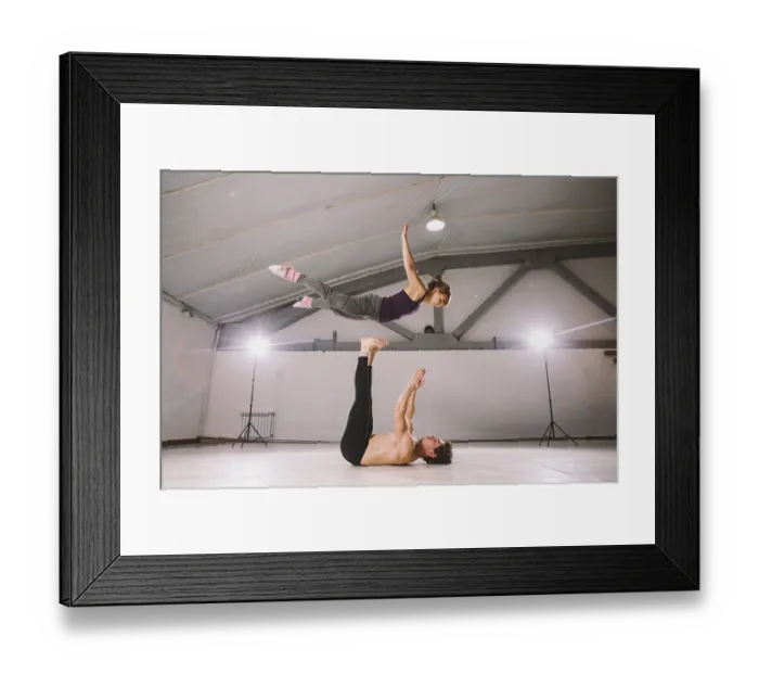 Framed Print : Young couple Couple practicing acro yoga in gym Framed Print : Young couple Couple practicing acro yoga in gym