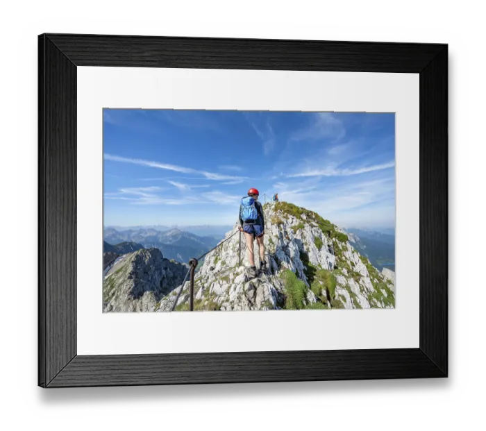 Framed Print : Mountaineer on a ridge on a secured via ferrata