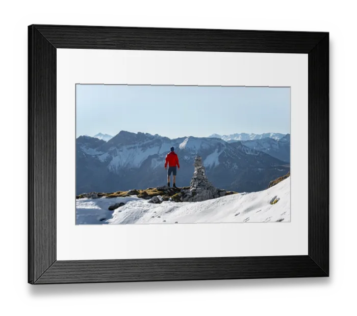 Framed Print : Mountaineer next to a cairn, in front of snowy mountains of the Rofan