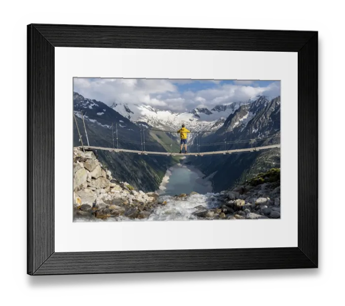 Framed Print : Mountaineers on a suspension bridge over a mountain stream Alelebach
