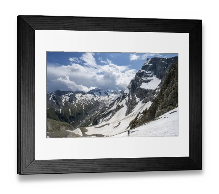 Framed Print : Mountaineer hiking in a snowfield